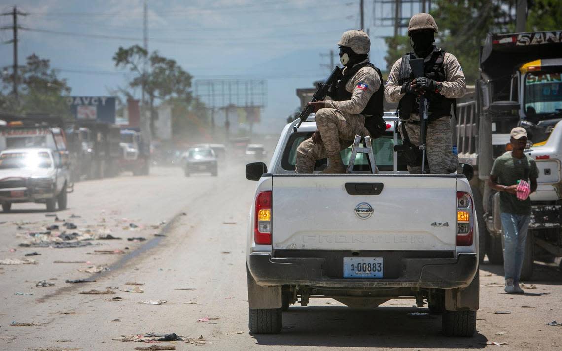 Haiti police on patrol keep their eyes on traffic during a stop at a police checkpoint in Tabarre, near the U.S. Embassy, just east of metropolitan Port-au-Prince. The powerful 400 Mawozo gang and its allies are trying to extend their control to the area.