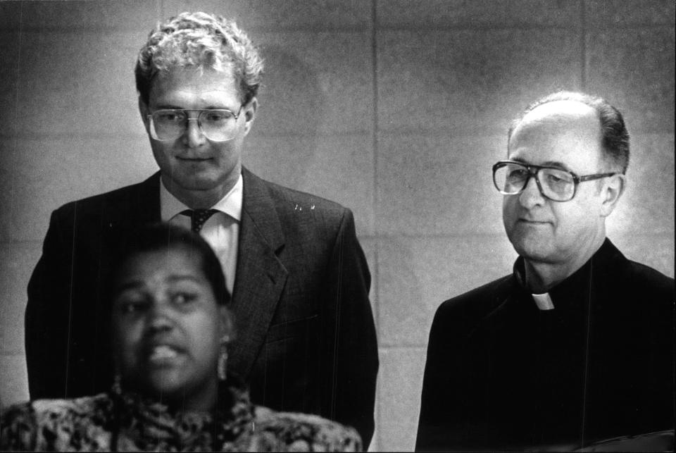 Mayor John O. Norquist (left) and Archbishop Rembert Weakland listened to a speaker while at an event to help the poor. This is a 1989 Press Photo.