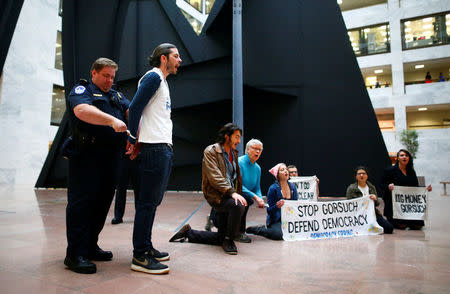 Members of Democracy Spring demonstrating against the Supreme Court nomination of Neil Gorsuch are taken into custody by law enforcement on Capitol Hill in Washington, U.S., April 6, 2017. REUTERS/Eric Thayer