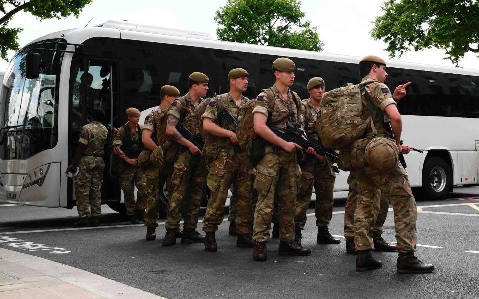 British soldiers arrive by bus and head towards a building next to New Scotland Yard headquarters - Credit: JUSTIN TALLIS/AFP