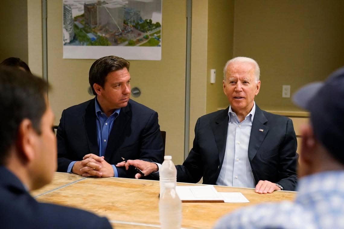 President Joe Biden, right, touches Gov. Ron DeSantis’ arm as he speaks during a briefing with first responders and local officials in a meeting after the collapse of Champlain Towers South in Surfside in June 2021.