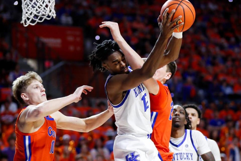 Kentucky guard Antonio Reeves (12) gets a rebound against Florida forward Alex Condon during Saturday’s game. Reeves was one of five UK players who scored in double figures versus the Gators.