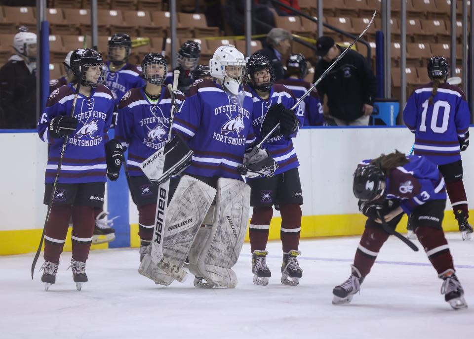 Goalie Sage Bussiere and members of the Oyster River/Portsmouth girls hockey team begin to skate off the ice following Saturday's 2-1 loss to Hanover in the Division I state championship game at Southern New Hampshire University Arena.