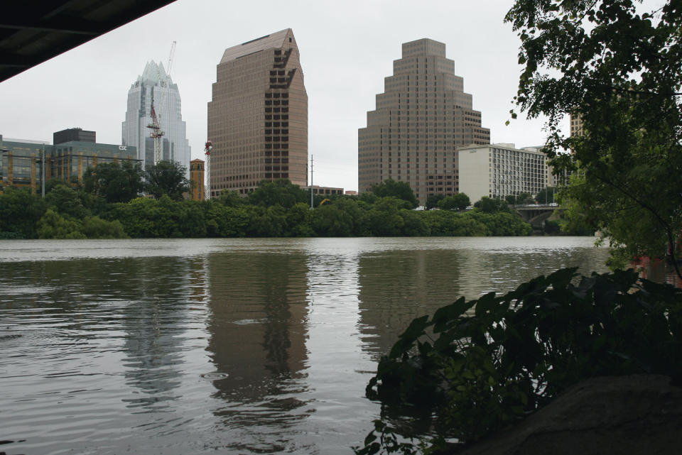 A part of the city skyline is reflected in Town Lake Thursday, July 26, 2007, in Austin, Texas. The city council is to rename it "Lady Bird Lake," in honor of Lady Bird Johnson who died on July 11, 2007. The former first lady was an early supporter of environmental issues and known for her efforts toward  beautification of the nation's countryside. The lake is filled with impounded waters of the Colorado River.  (AP Photo/Harry Cabluck)