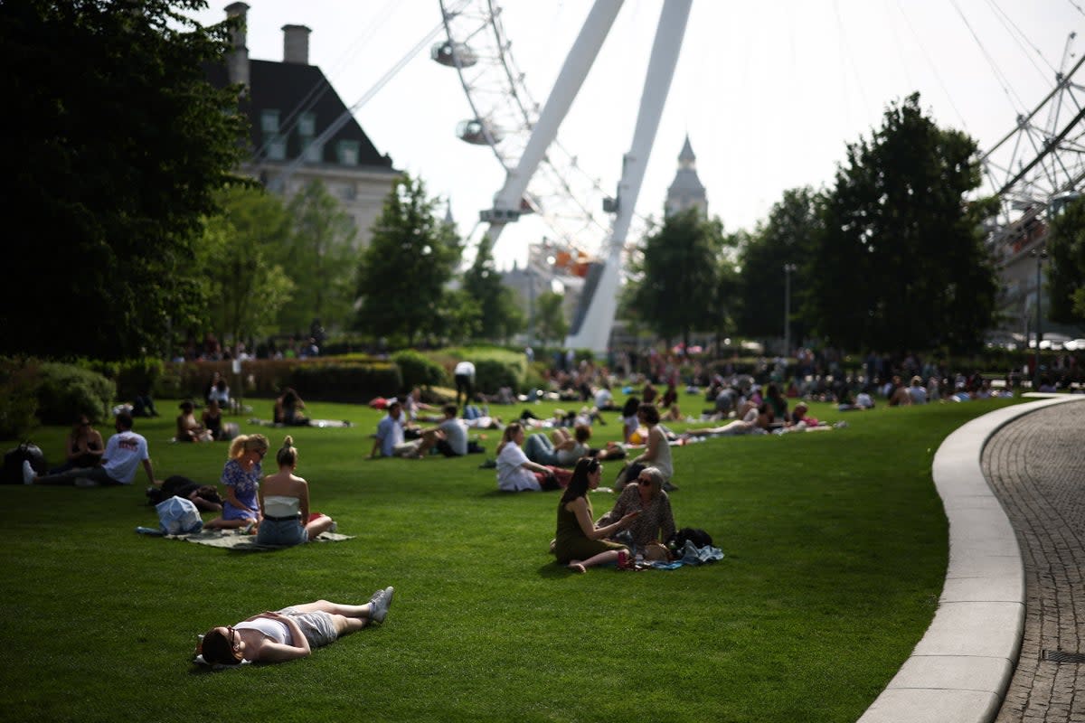 People enjoying the sun by the London Eye on Saturday (AFP via Getty Images)