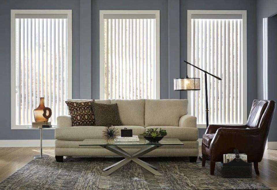 Living room with vertical blinds in three tall windows