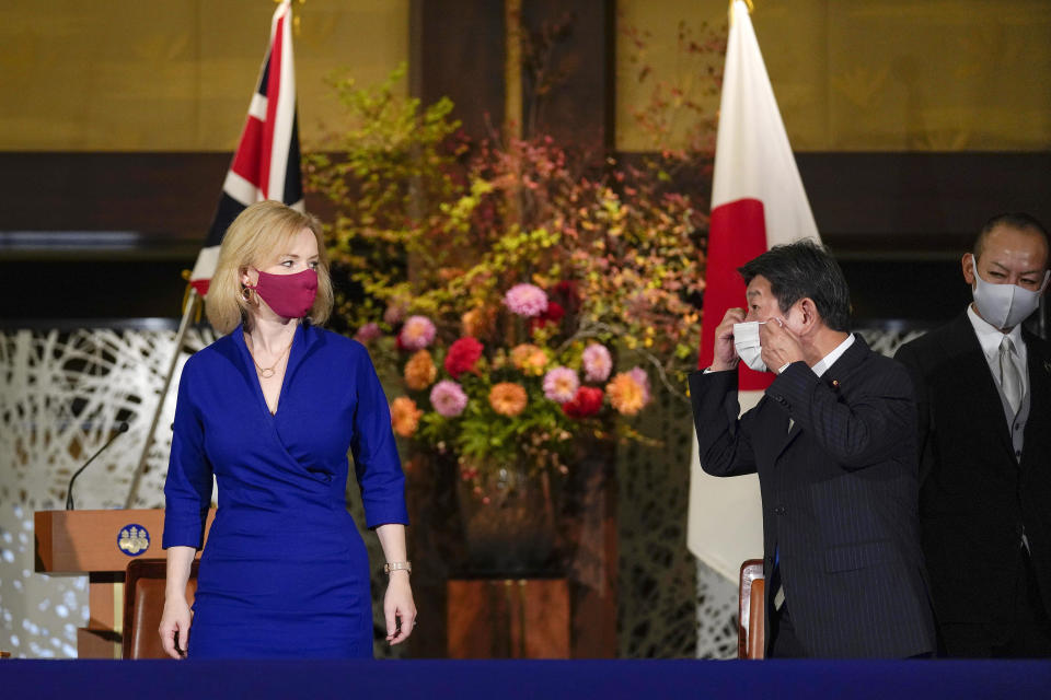 British International Trade Secretary Liz Truss, left, attends a signing ceremony with Japanese Foreign Minister Toshimitsu Motegi, second right, to sign for economic partnership between Japan and Britain at Iikura Annex of the Foreign Ministry in Tokyo Friday, Oct. 23, 2020. Japan and Britain signed a bilateral free trade deal Friday in the the first such major post-Brexit deal, reducing tariffs on Yorkshire lamb sold in Japan, as well as auto parts for Japan’s Nissan plant. (Kimimasa Mayama/Pool Photo via AP)