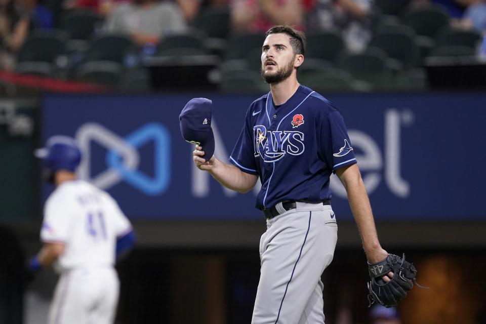 Tampa Bay Rays relief pitcher Ryan Thompson walks back to the mound after giving up a two-run double to Texas Rangers' Mitch Garver in the sixth inning of a baseball game, Monday, May 30, 2022, in Arlington, Texas. (AP Photo/Tony Gutierrez)