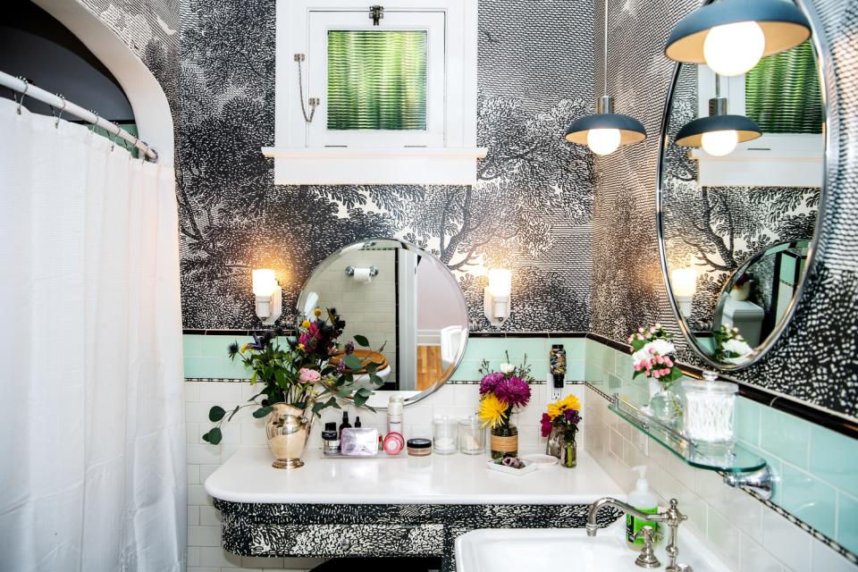 The metallic-wallpapered master bathroom.