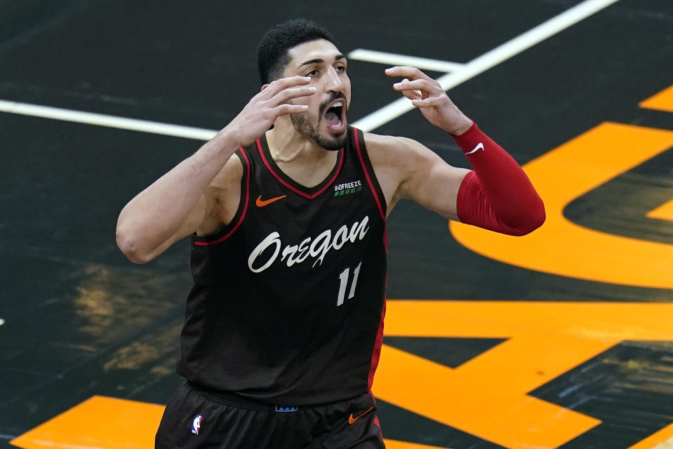 Portland Trail Blazers center Enes Kanter reacts after missing a pass and letting the ball go out of bounds for a turnover during the second half of an NBA basketball game against the Orlando Magic, Friday, March 26, 2021, in Orlando, Fla. (AP Photo/John Raoux)