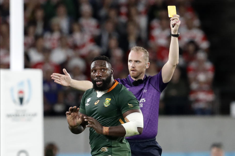 Referee Wayne Barnes shows a yellow card to South Africa's Tendai Mtawarira during the Rugby World Cup quarterfinal match at Tokyo Stadium between Japan and South Africa in Tokyo, Japan, Sunday, Oct. 20, 2019. (AP Photo/Mark Baker)