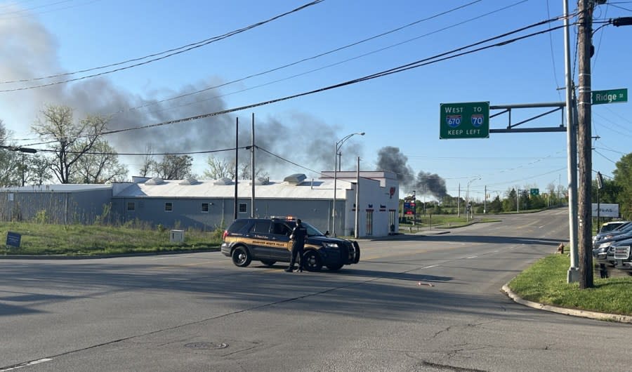 Smoke exiting the back of a semi-truck trailer has caused the evacuation of an area in North Franklinton. (NBC4/Ronald Clark)