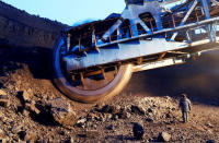 FILE PHOTO: An employee walks near a rotary dredge which works on the coal face of the Borodinsky opencast colliery, near the Siberian town of Borodino, east of Krasnoyarsk, Russia December 9, 2014. REUTERS/Ilya Naymushin/File Photo