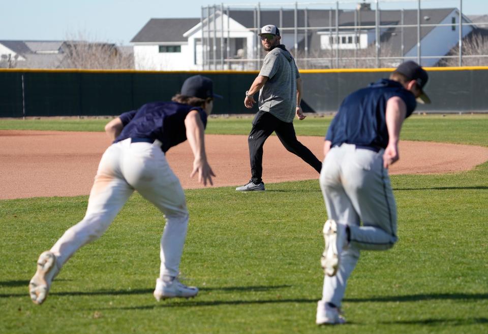 Casteel baseball head coach Matt Denny works with his team during practice at Casteel HS baseball field in Queen Creek on Feb. 12, 2024.