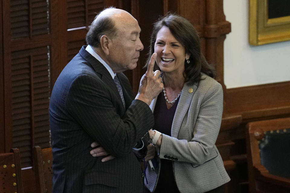 Texas State Sen. Angela Paxton, R-McKinney, wife of suspended Texas state Attorney General Ken Paxton, right, talks with State Sen. Juan "Chuy" Hinojosa, D-McAllen, during the impeachment trial her husband in the Senate Chamber at the Texas Capitol, Thursday, Sept. 14, 2023, in Austin, Texas. (AP Photo/Eric Gay)