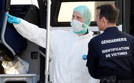 French investigators talk together outside a Gendarmerie mobile forensic van in Seynes-les-Alpes near the crash site of a Germanwings Airbus A320, in the French Alps March 27, 2015. REUTERS/Eric Gaillard