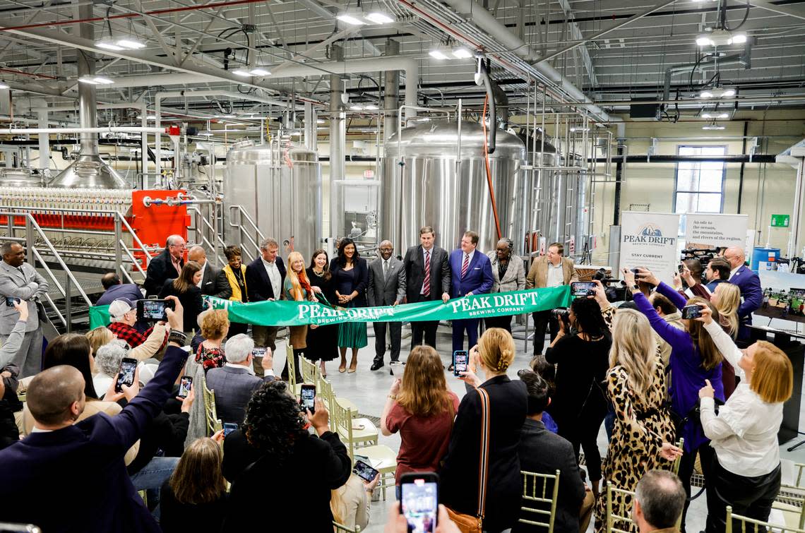 A ribbon is cut during an opening celebration at Peak Drift Brewing in Columbia on Wednesday, Jan. 18, 2023.