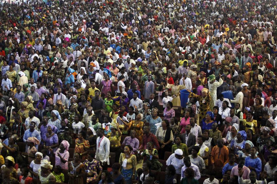 Worshippers attend a church service at the Living Faith Church, also known as the Winners' Chapel, in Ota district, Ogun state, some 60 km (37 miles) outside Nigeria's commercial capital Lagos September 28, 2014. Hundreds of millions of dollars change hands each year in Nigeria's popular Pentecostal "megachurches", which are modelled on their counterparts in the United States. Some of these churches can hold more than 200,000 worshippers and, with their attendant business empires, they constitute a significant section of the economy, employing tens of thousands of people and raking in tourist dollars, as well as exporting Christianity globally. To match Insight NIGERIA-MEGACHURCHES/ Picture taken September 28, 2014. REUTERS/Akintunde Akinleye (NIGERIA - Tags: RELIGION BUSINESS)