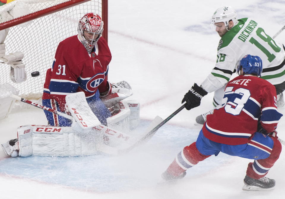 Dallas Stars' Jason Dickinson (18) moves in on Montreal Canadiens goaltender Carey Price as Canadiens' Victor Mete (53) defends during the second period of an NHL hockey game Saturday, Feb. 15, 2020, in Montreal. (Graham Hughes/The Canadian Press via AP)