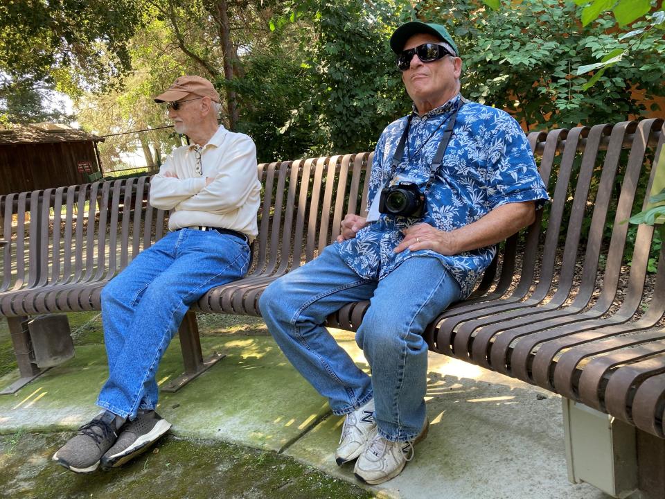 Visitor Gary Pierce and docent Jack Jacobs take in a cool stop on one of the talking benches.