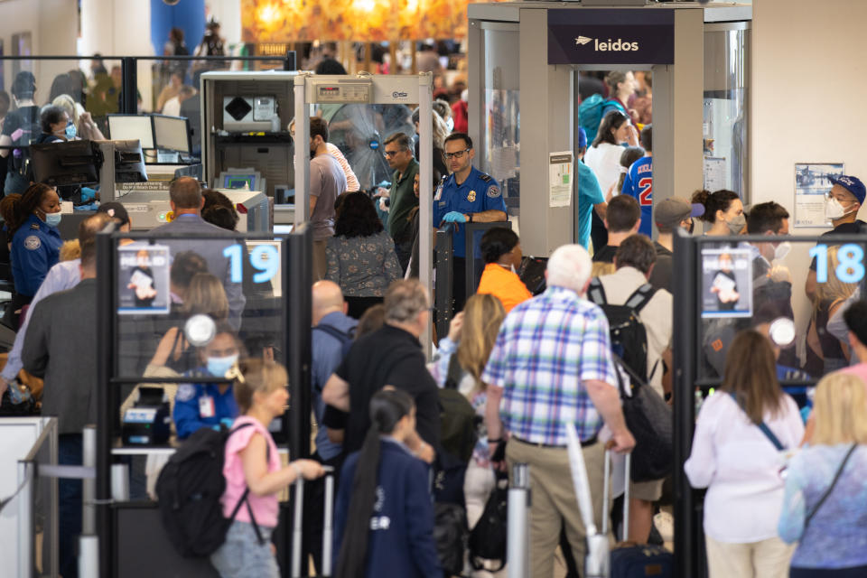 NEWARK, NJ - JULY 01: Travelers line up to enter a security checkpoint at Newark Liberty International Airport (EWR) on July 1, 2022 in Newark, New Jersey. Hundreds of flights were canceled across the US ahead of July Fourth weekend. (Photo by Jeenah Moon/Getty Images)