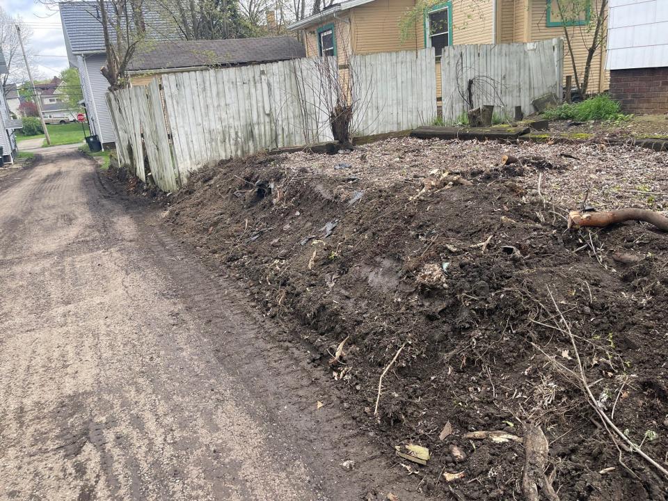 Brush, trees and debris were cleared from this alley in Canton by Dirty Hands Excavating and Restoration as part of Mayor William V. Sherer II's neighborhood transformation initiative. Sherer wants to pave every alley in the city over the next four years.