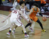 Oklahoma State guard Cade Cunningham (2) goes against Oklahoma forward Brady Manek (35) and forward Jalen Hill (1) during the second half of an NCAA college basketball game, Saturday, Feb. 27, 2021, in Norman, Okla. (AP Photo/Garett Fisbeck)