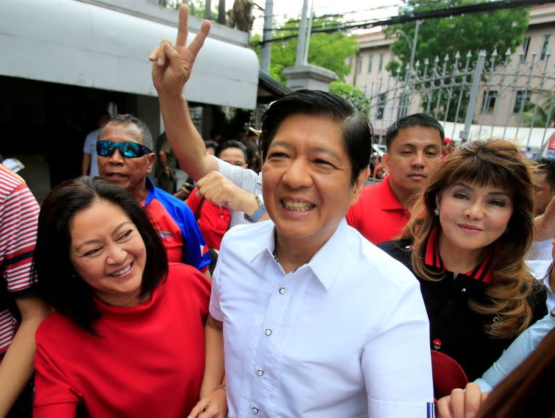 FILE PHOTO: Ferdinand "Bongbong" Marcos, son of late dictator Ferdinand Marcos, his wife, Louise (L) and his sister Imee (R) smile upon arrival at the Supreme Court in Padre Faura