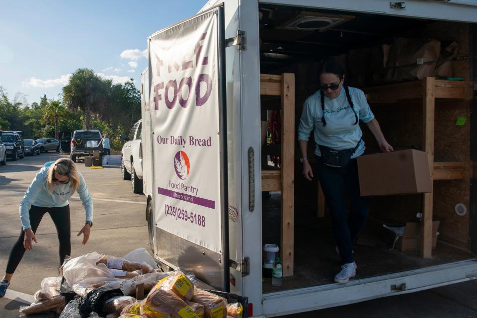 Volunteers fill bags during Our Daily Bread Food Pantry’s mobile food pantry, Wednesday, Nov. 24, 2021, at Naples Botanical Garden in Naples, Fla.Families received around 30 pounds of food, including meat, eggs, dairy, and fresh produce, along with cat/dog food and feminine products. More than 100 bags were given away.