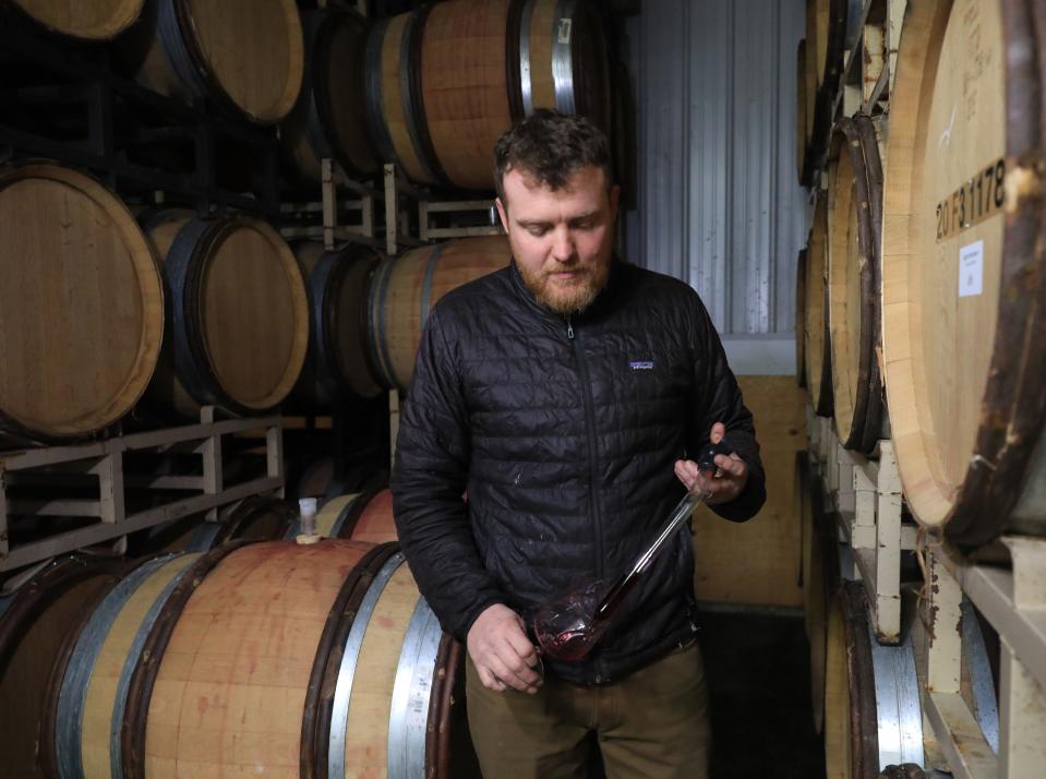 Ian Bearup, the winemaker at Millbrook Vineyards & Winery draws a sample of wine while in the barrel room at the winery on February 22, 2024.