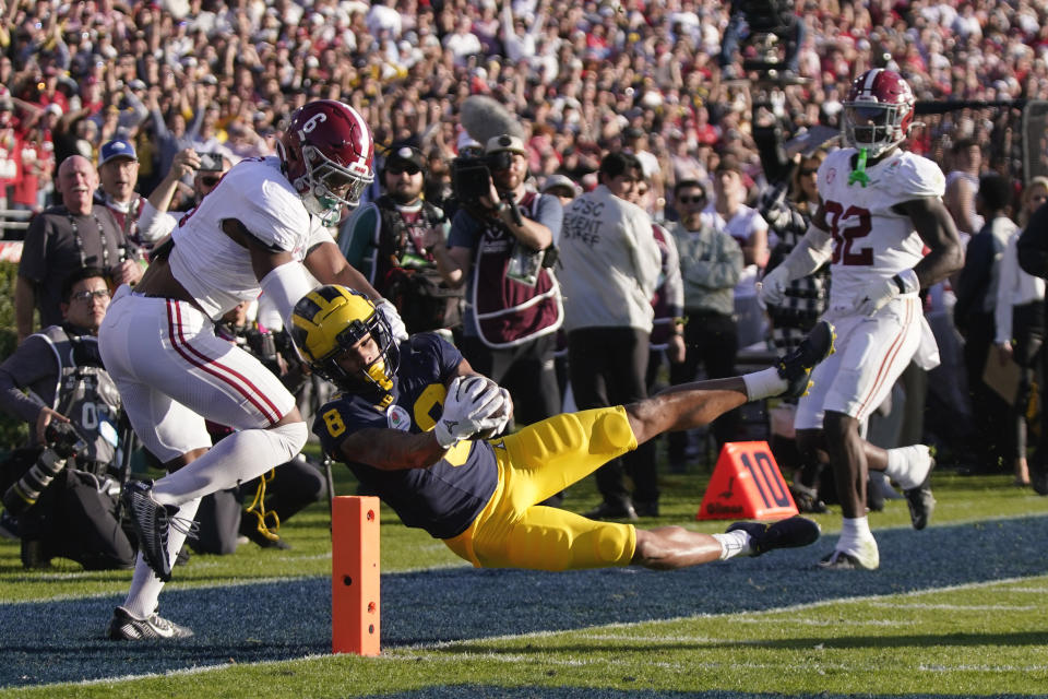 Michigan wide receiver Tyler Morris (8) scores a touchdown past Alabama defensive back Jaylen Key (6) and linebacker Deontae Lawson (32) and during the first half of the Rose Bowl CFP NCAA semifinal college football game Monday, Jan. 1, 2024, in Pasadena, Calif. (AP Photo/Mark J. Terrill)