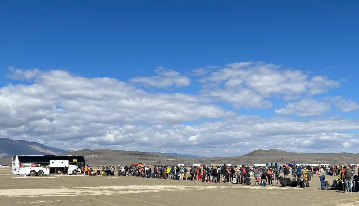 People wait in line for a bus to leave the Burning Man festival in Black Rock Desert, Nevada, USA, 04 September 2023 (EPA)