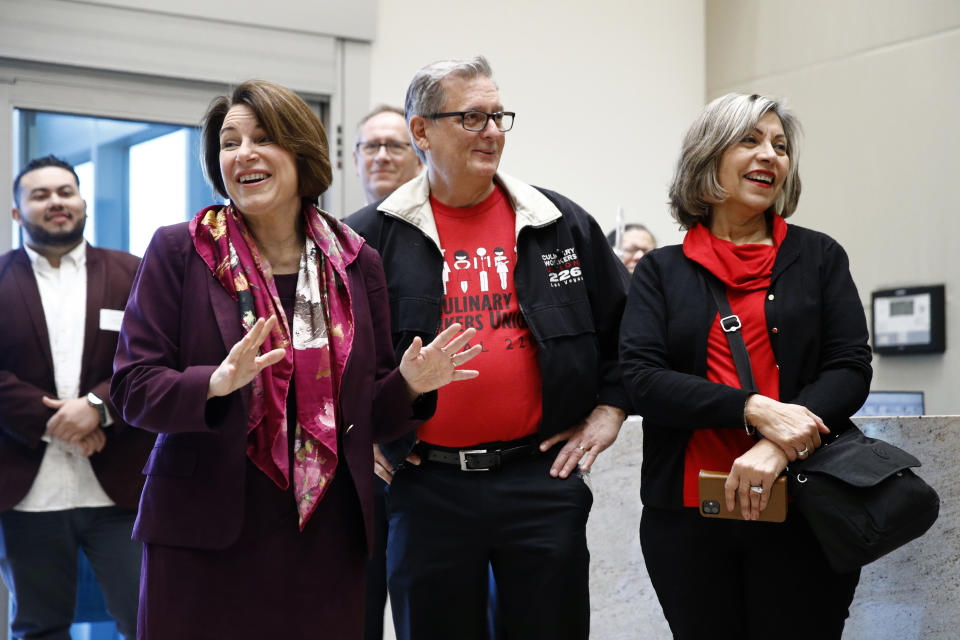 Democratic presidential candidate Sen. Amy Klobuchar, D-Minn., left, tours the Culinary Health Center with Culinary Union president Ted Pappageorge, center, and secretary-treasurer Geoconda Arguello-Kline, Friday, Feb. 14, 2020, in Las Vegas. (AP Photo/Patrick Semansky)