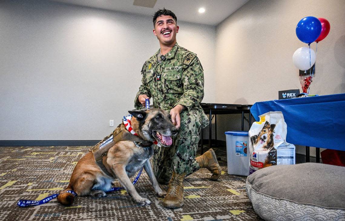 Carlos Aranda, a military dog handler from NAS Lemoore, greets his former service dog “Donnie” for the first time in a year during a reunion organized by Paws of War at the Hampton Inn in Selma on Monday, Aug. 26, 2024.