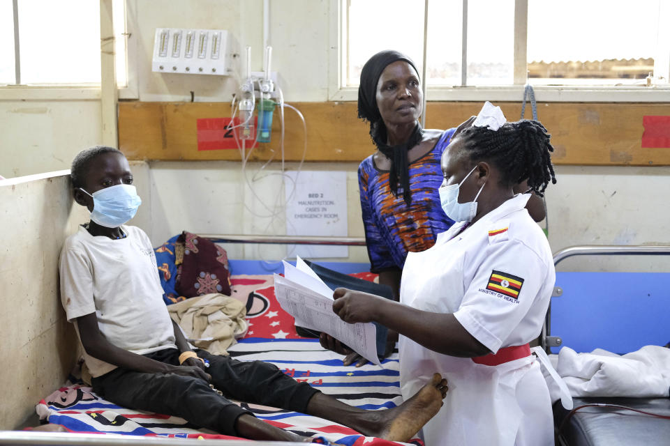 A nurse is assessing John Elugalt's condition inside the emergency room at the Mbale Regional Referral Hospital, in Mbale, Uganda, Wednesday, April 24, 2024. (AP Photo/Hajarah Nalwadda)