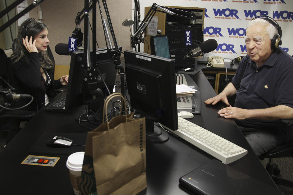 This May 20, 2012 image shows Arthur Frommer, 83, and his daughter, Pauline Frommer, 46, as they prepare for their radio show at the WOR studios in New York. The father-daughter team, host a live weekly call-in radio show together, called “The Travel Show,” on WOR-AM, which is carried on 115 radio stations across the U.S. (AP Photo/Seth Wenig)