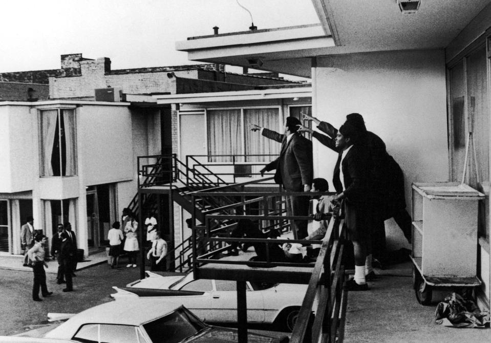 People on the balcony of Lorraine Motel in Memphis, Tennessee, point in direction of gunshots April 4, 1968, after the assassination of civil rights leader the Rev. Dr. Martin Luther King Jr., who is lying at their feet.