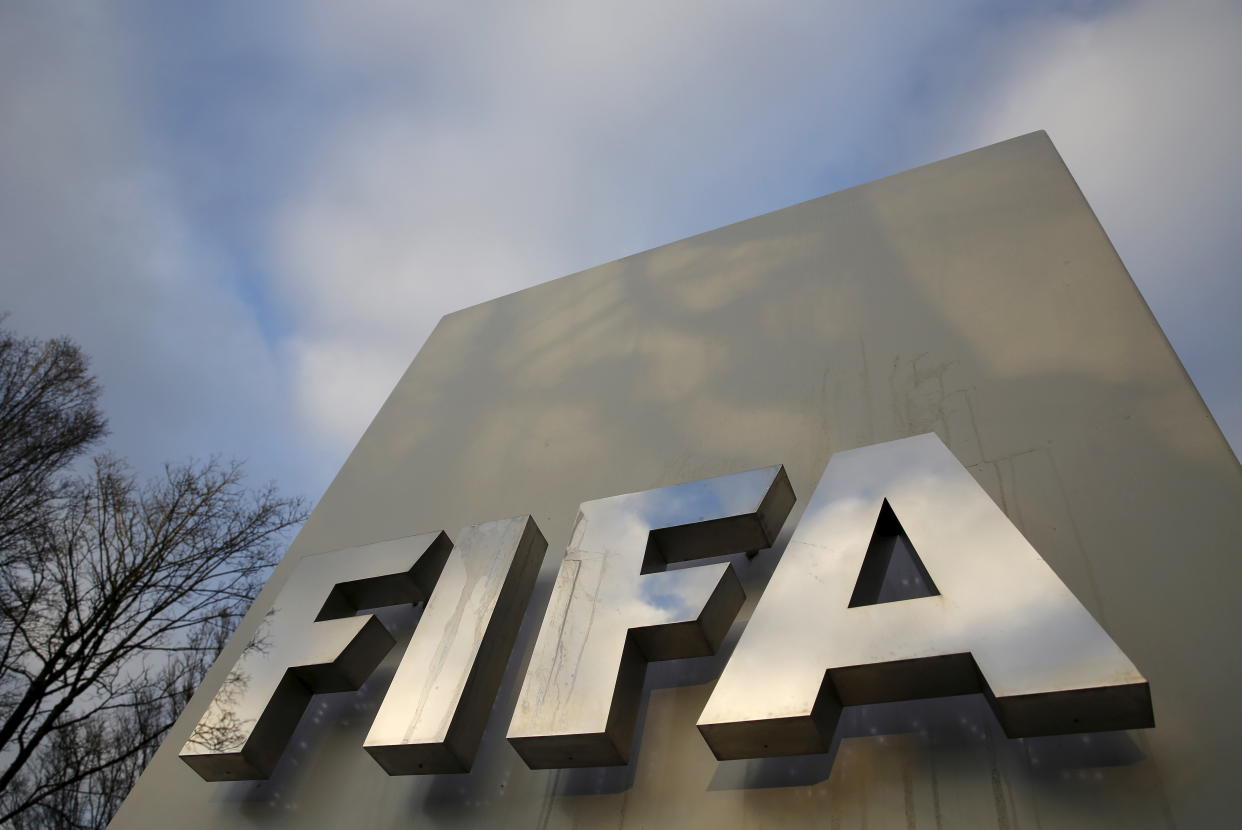 A FIFA sign is seen outside the FIFA headquarters in Zurich, Switzerland December 17, 2015. REUTERS/Ruben Sprich