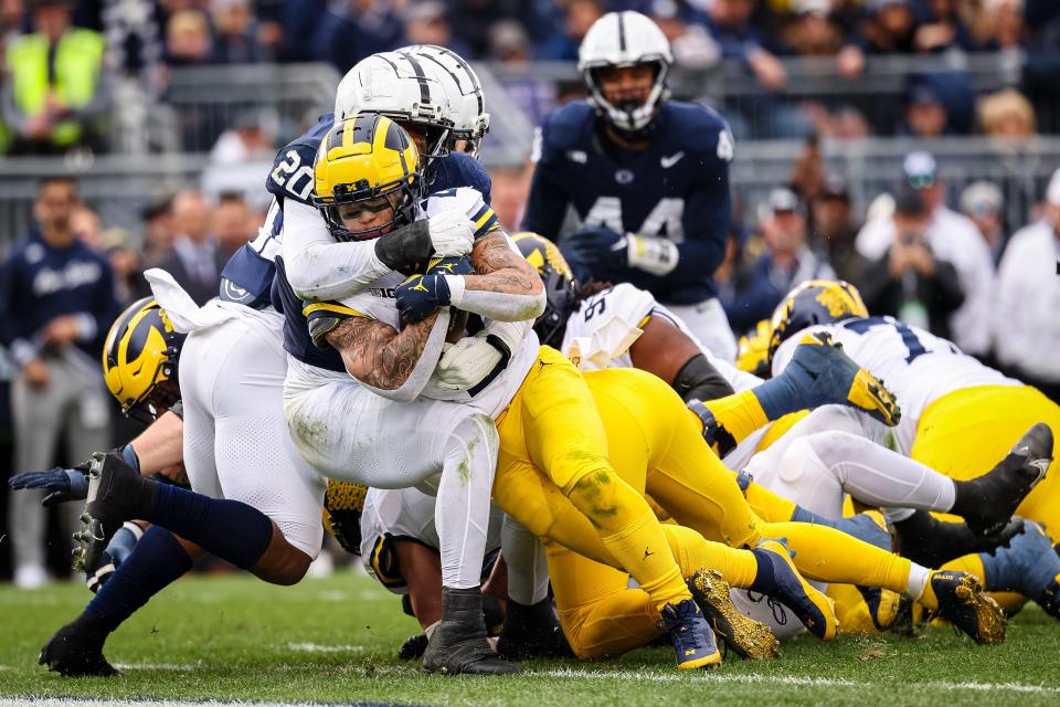 Blake Corum of the Michigan Wolverines runs for a touchdown against the Penn State Nittany Lions during the first half at Beaver Stadium on November 11, 2023 in State College, Pennsylvania.