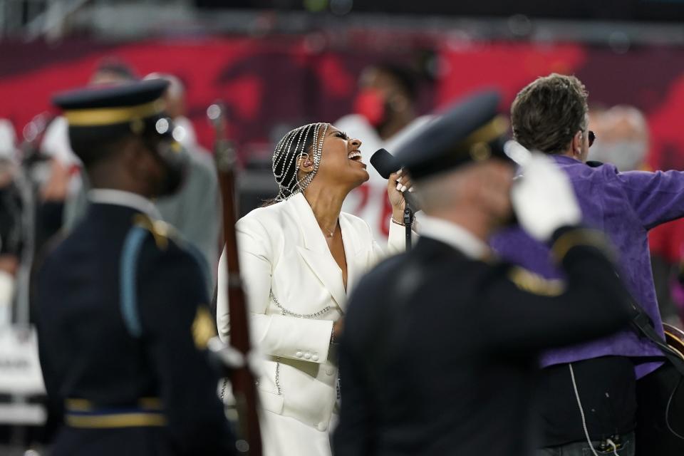 Eric Church, right, and Jazmine Sullivan perform the national anthem before the NFL Super Bowl 55 football game between the Kansas City Chiefs and Tampa Bay Buccaneers, Sunday, Feb. 7, 2021, in Tampa, Fla. (AP Photo/Lynne Sladky)