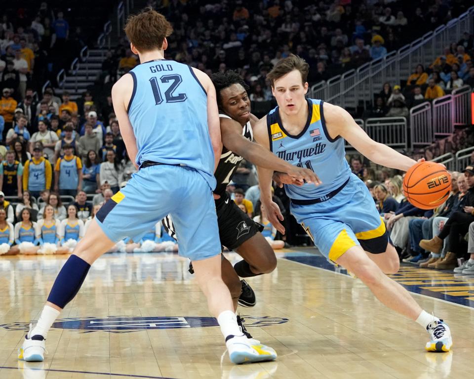 Marquette guard Tyler Kolek uses a pick by forward Ben Gold on Providence guard Jayden Pierre during the first half Wednesday night at Fiserv Forum in Milwaukee,