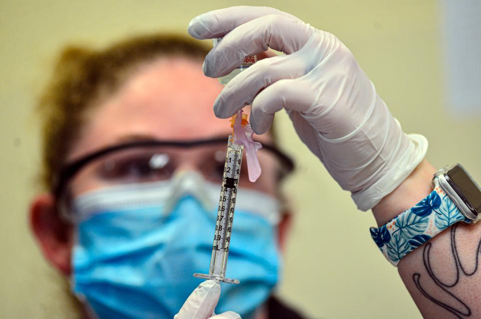 Cheri Rose, a medical assistant at Brattleboro Memorial Hospital in Vermont, draws the Moderna COVID-19 vaccine into a syringe on Wednesday during a vaccination clinic for people 75 years and older.