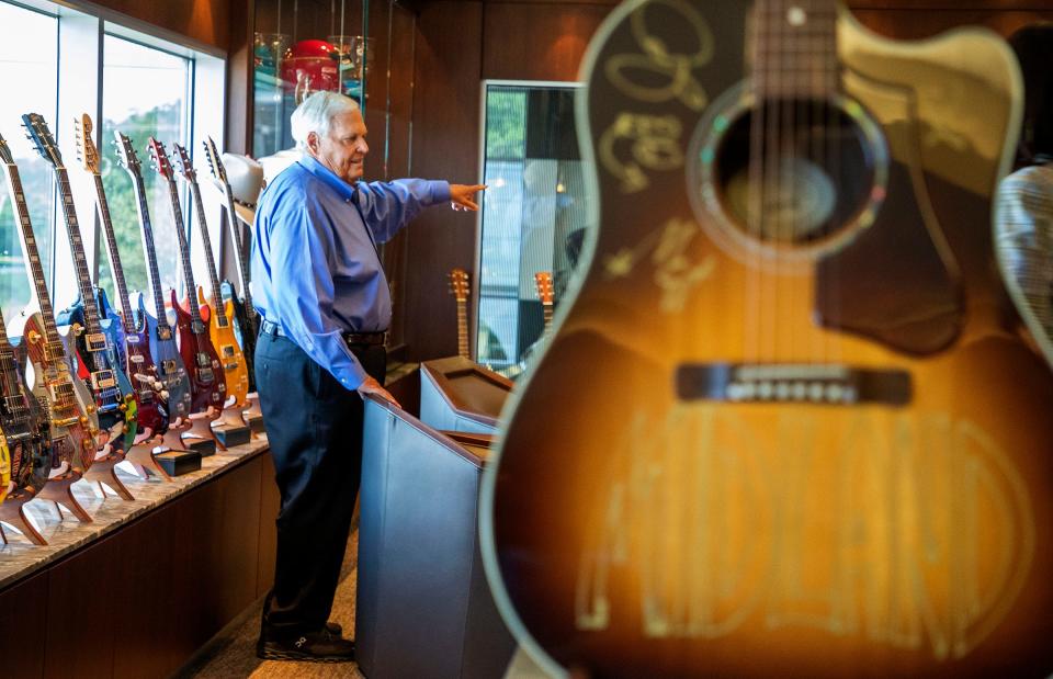 Rick Hendrick talks inside of the second-floor room where dozens of signed guitars and photographs and other memorabilia are on display inside the 58,000-square-foot Heritage Center in Concord, North Carolina, on July 25, 2023.