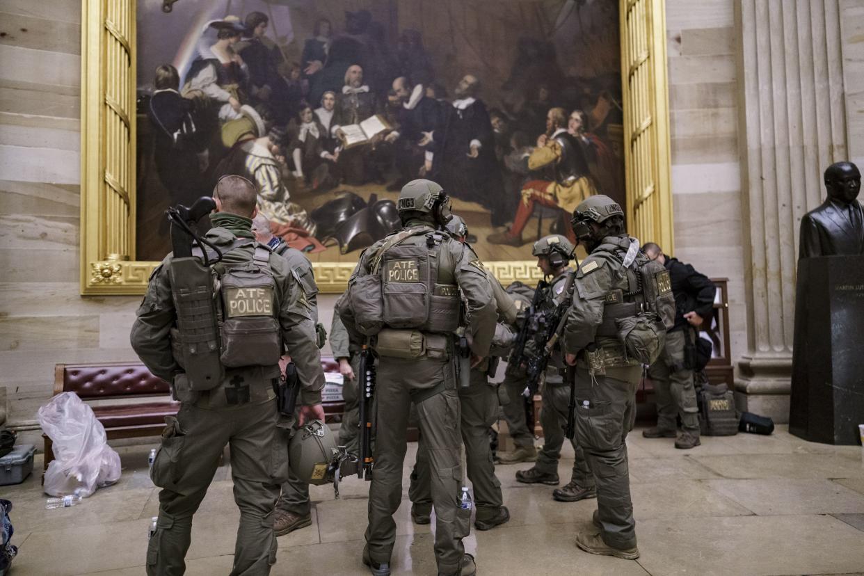After violent protesters loyal to President Donald Trump stormed the U.S. Capitol today, a tactical team with ATF gathers in the Rotunda to provide security for the continuation of the joint session of the House and Senate to count the Electoral College votes cast in November's election, at the Capitol in Washington, Wednesday, Jan. 6, 2021.