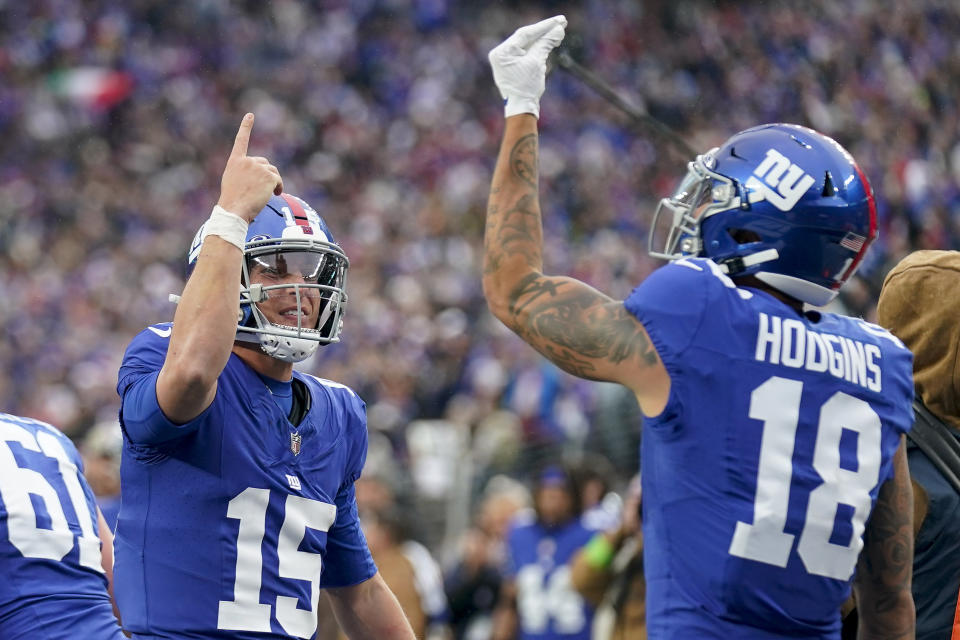 New York Giants quarterback Tommy DeVito (15) celebrates with wide receiver Isaiah Hodgins (18) after Hodgins caught a touchdown pass against the New England Patriots during the third quarter of an NFL football game, Sunday, Nov. 26, 2023, in East Rutherford, N.J. (AP Photo/Seth Wenig)