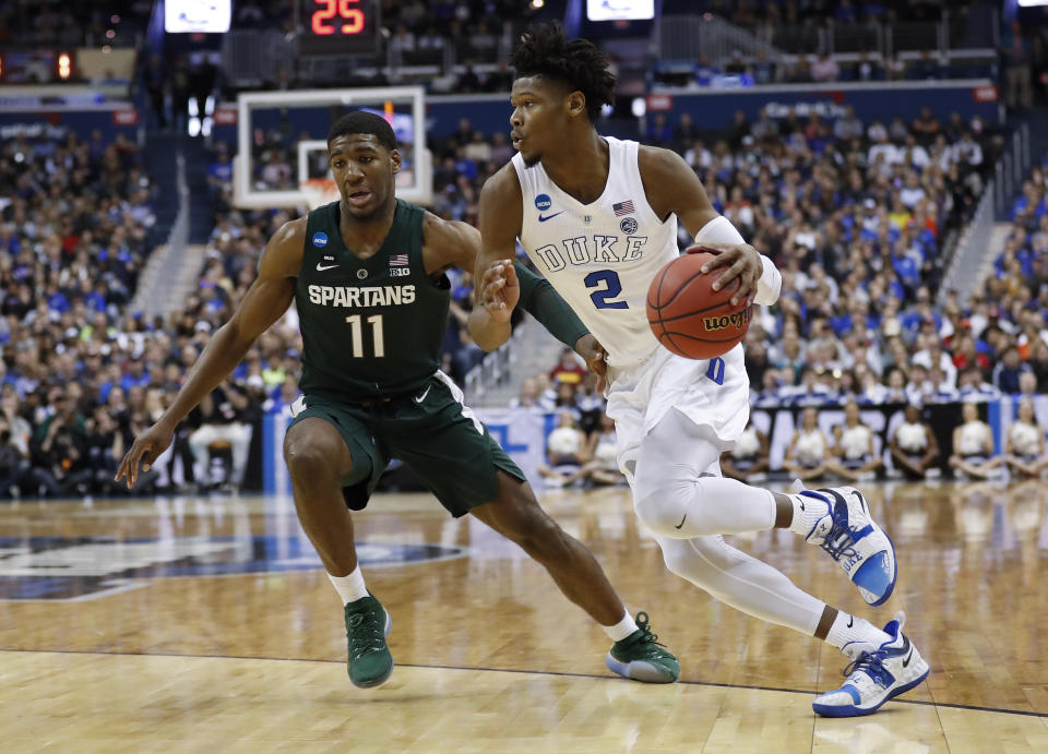 Duke forward Cam Reddish (2) drives around Michigan State forward Aaron Henry (11) during the first half of an NCAA men's East Regional final college basketball game in Washington, Sunday, March 31, 2019. (AP Photo/Patrick Semansky)