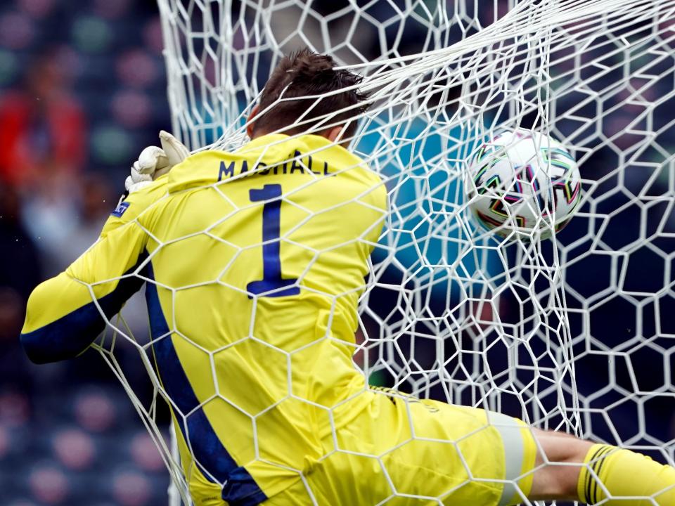 Scotland goalkeeper David Marshall crashes into the back of the net after conceding the second goal scored by Czech Republic's Patrik Schick.