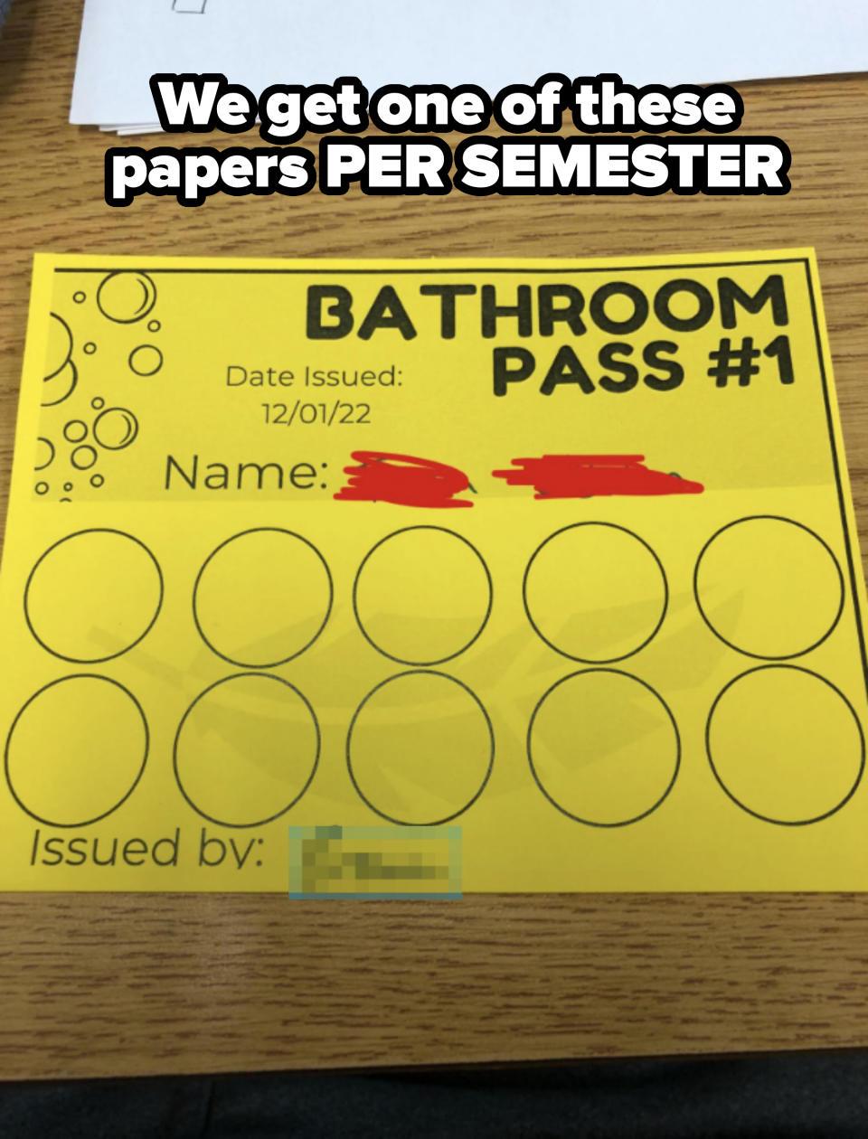 A yellow bathroom pass card titled "Bathroom Pass #1" with circles for markings. Issued on 12/01/22 by Brown