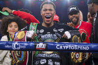 Devin Haney, center, of the United States, poses with his belts after defeating Australia's George Kambosos in their WBC lightweight title fight in Melbourne, Australia, Sunday, June 5, 2022. Haney retained his WBC lightweight title and added three more from the weight class with a unanimous points decision over Australian George Kambosos. (James Ross/AAPImage via AP)