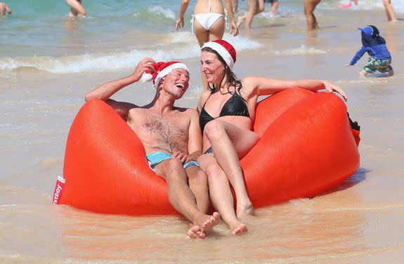 Frank Groot and Josephine Groot, from Amsterdam, The Netherlands, play on their inflatable couch.